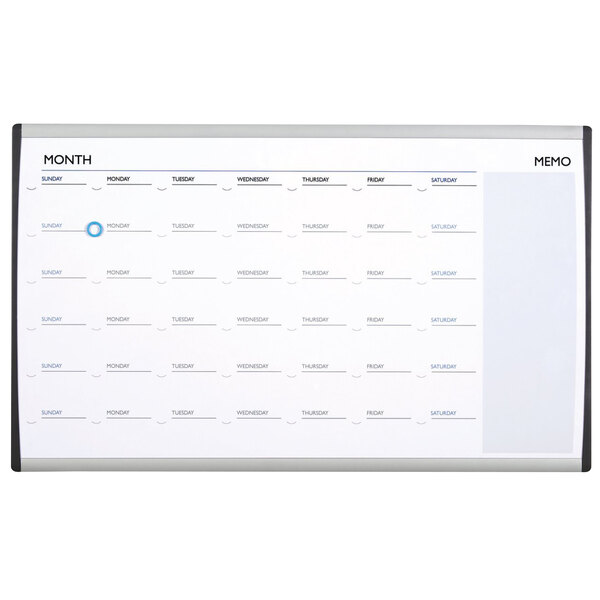 A white magnetic steel Quartet calendar with silver aluminum frame and black and blue lines.