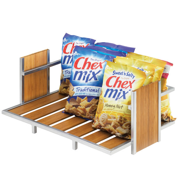 A Cal-Mil single tier merchandiser holding bags of Chex Mix on a table.