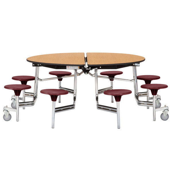 A National Public Seating round cafeteria table with a metal base and seats on wheels.