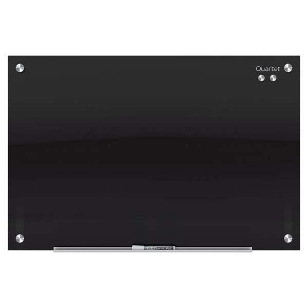 A Quartet black glass magnetic markerboard with silver screws.