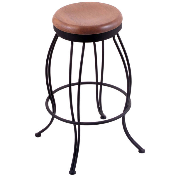 A Holland Bar Stool with a wooden seat and black steel base.