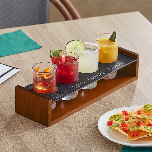 An Acopa Write-On flight carrier with Straight Up Tasting Glasses on a table with a group of drinks.