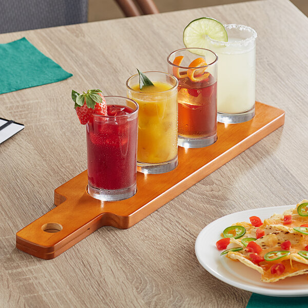 An Acopa dual-sided wooden flight paddle with Straight Up tasting glasses holding a variety of drinks.