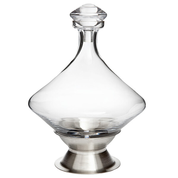 A Franmara Orbital crystal decanter with a stainless steel base.