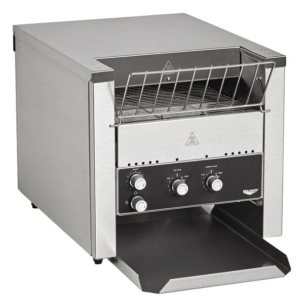 A stainless steel Vollrath conveyor toaster on a counter.