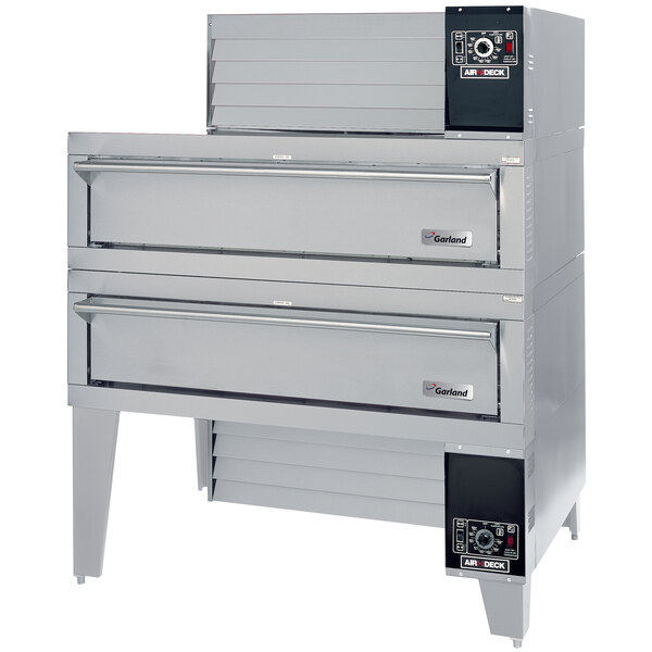 A large grey Garland double pizza deck oven with drawers.