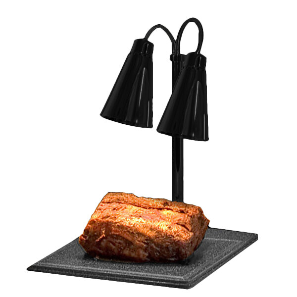 A piece of meat on a square plate with two black Hanson Heat Lamps.
