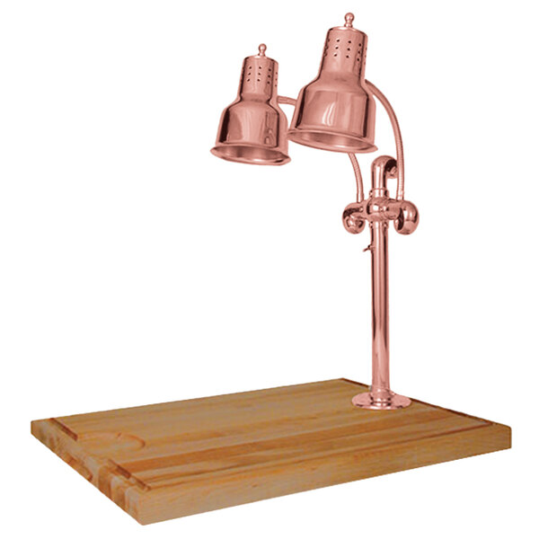 A Hanson Heat Lamps bright copper carving station with a maple base on a wood surface.