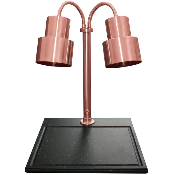 A Hanson Heat Lamps bright copper carving station with dual lamp posts on a black surface.