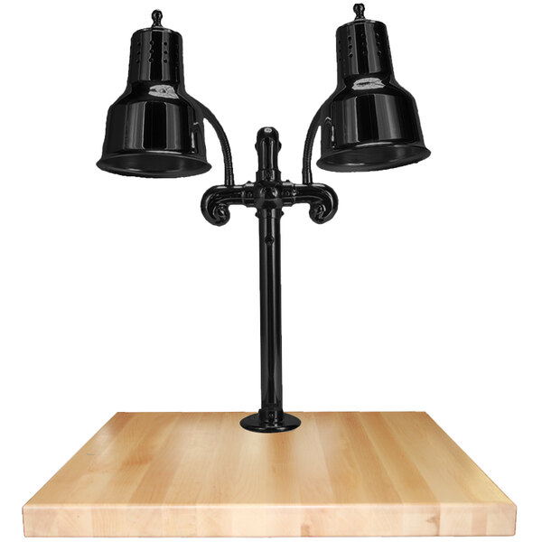 A Hanson Heat Lamps black dual bulb carving station on a wooden table.