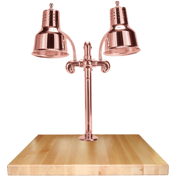 A Hanson Heat Lamps bright copper carving station on a maple surface.