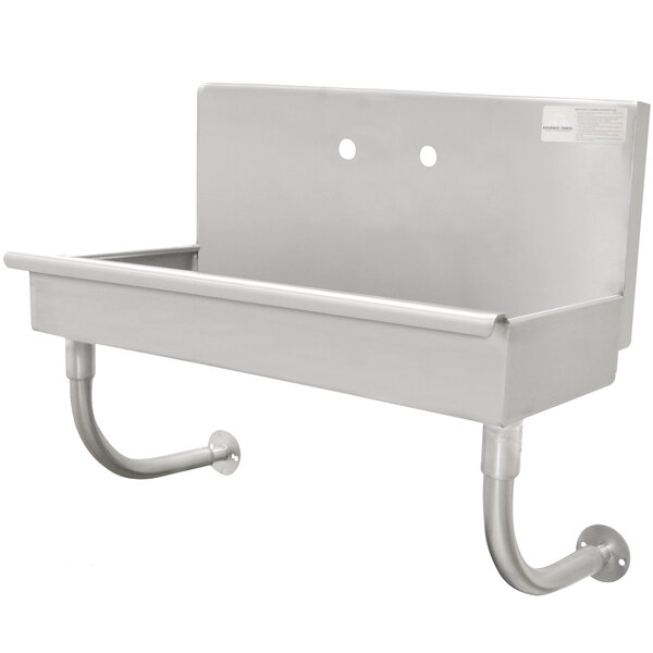 An Advance Tabco stainless steel wall mounted ADA hand sink with a metal shelf.