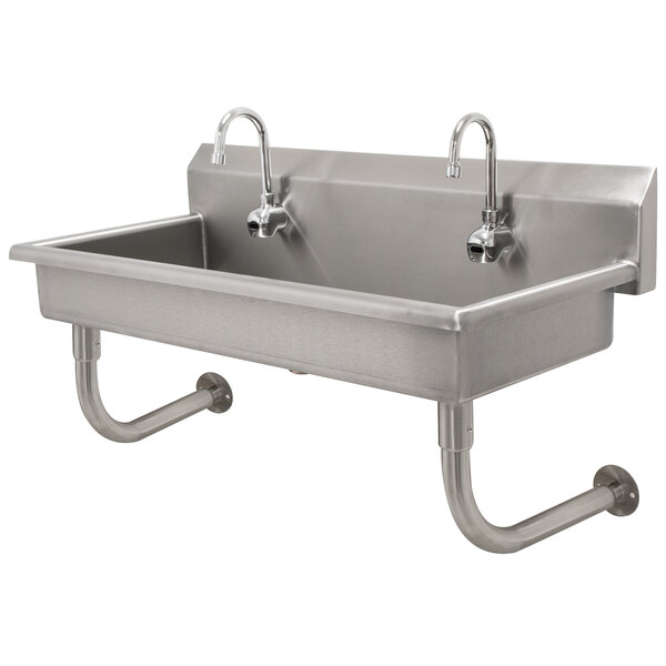 A stainless steel Advance Tabco multi-station hand sink with two faucets.