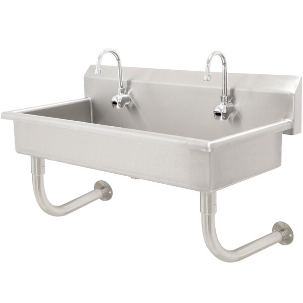 A stainless steel Advance Tabco hand sink with six electronic faucets.