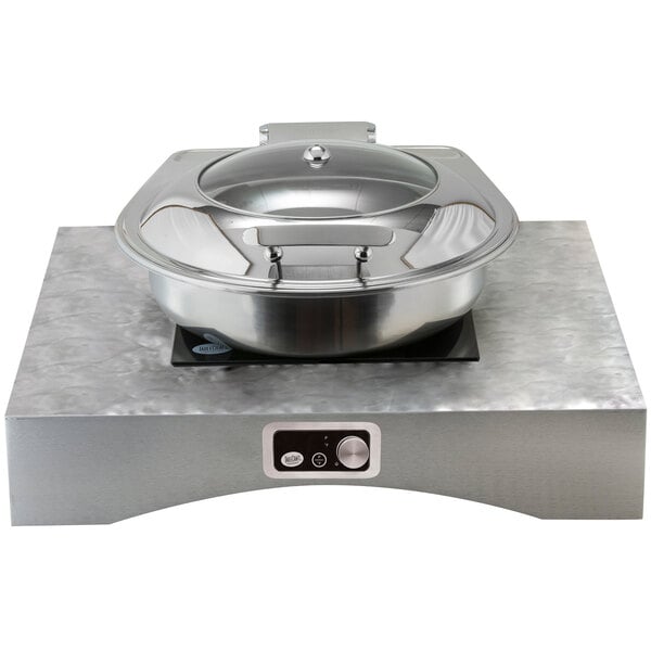 A silver pot with a lid in a Tablecraft aluminum countertop induction station kit.