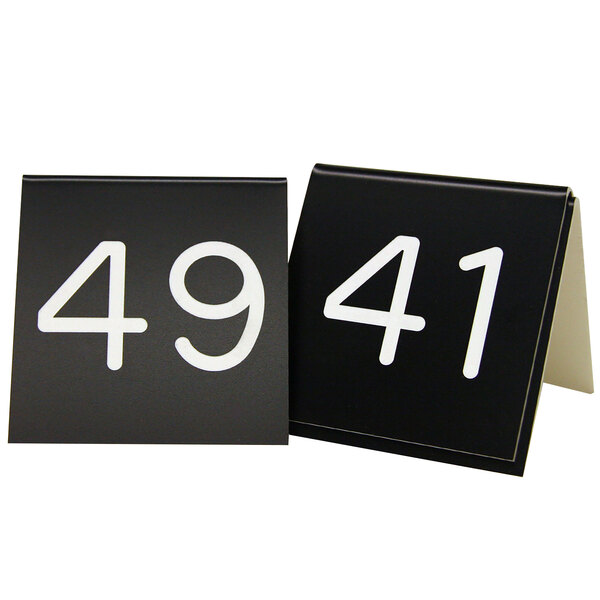 A black Cal-Mil table tent sign with white numbers.