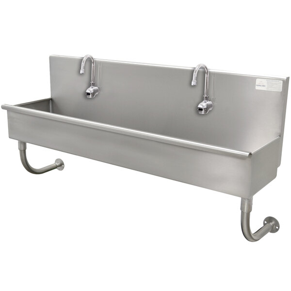 A stainless steel Advance Tabco multi-station hand sink with faucets.