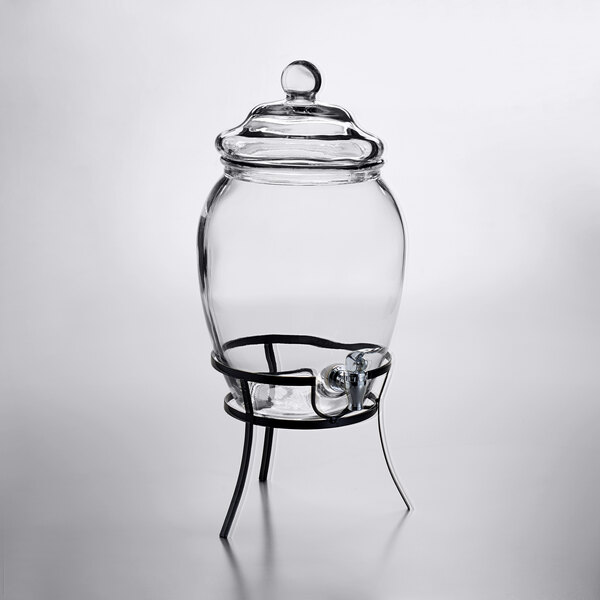 A Stylesetter clear glass jar with a metal stand and a drink dispenser tap.