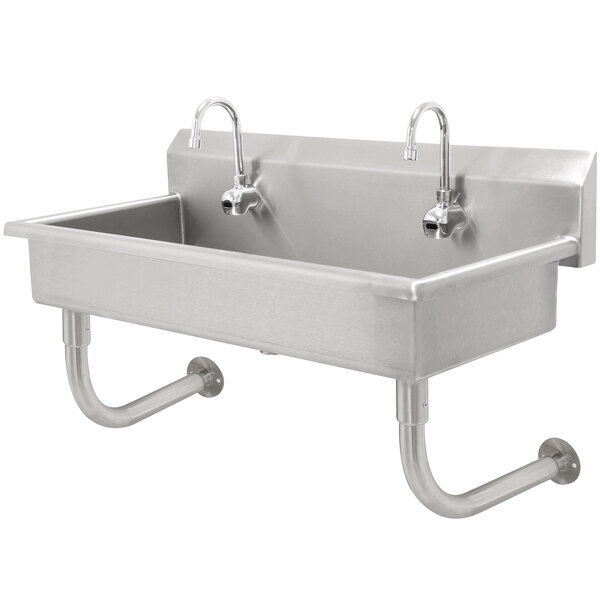 An Advance Tabco stainless steel hand sink with three electronic faucets.