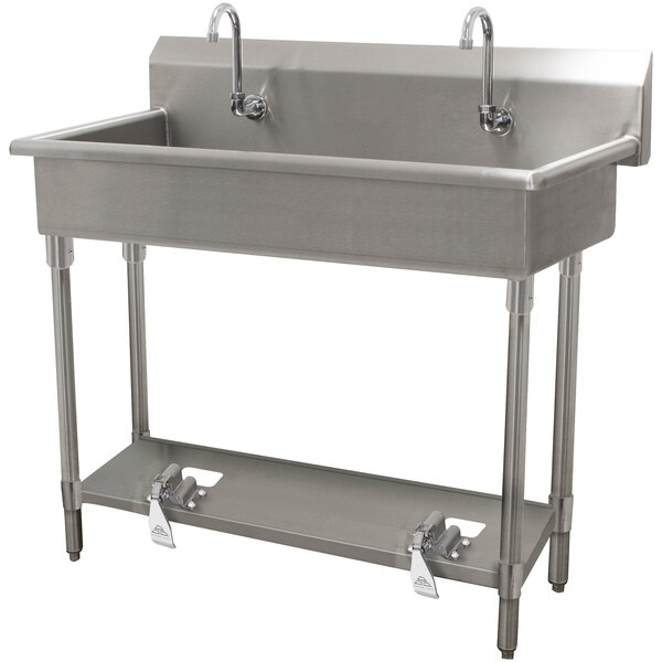 A stainless steel Advance Tabco hand sink with two faucets.