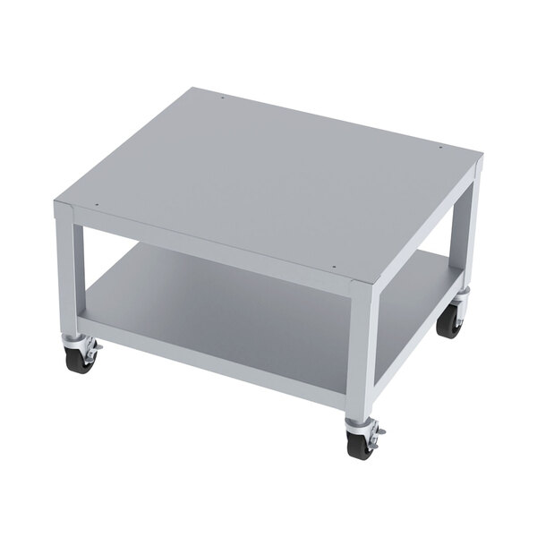 A white metal table with black wheels for a Garland HEMST Series mobile charbroiler stand.