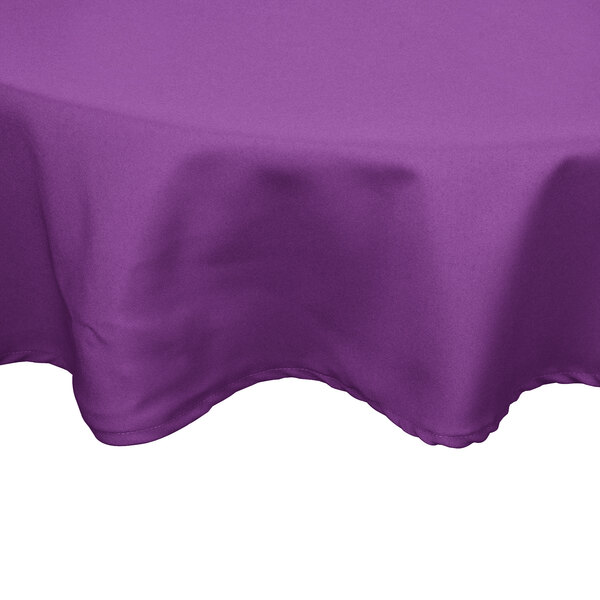 A purple Intedge round tablecloth on a table.