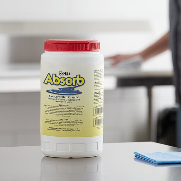 A white container of Noble Chemical Absorb on a counter.