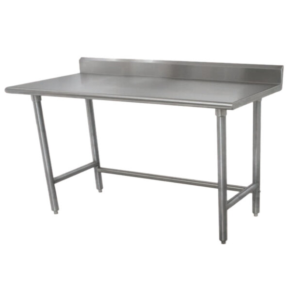 A stainless steel Advance Tabco work table with a backsplash and galvanized legs.