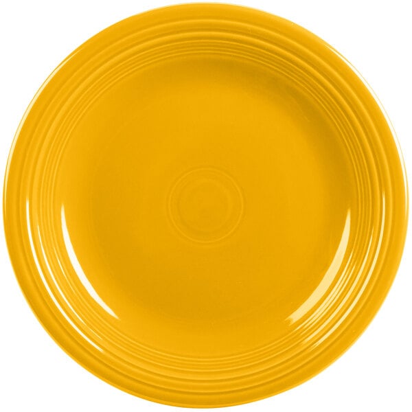 A yellow Fiesta dinner plate with a ring on the rim.