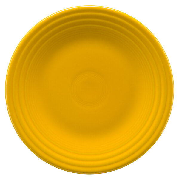 A yellow Fiesta luncheon plate with a circular pattern.