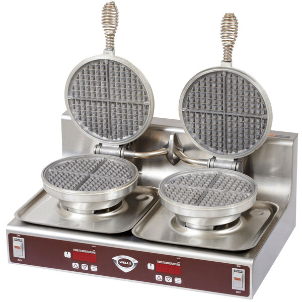 A white Wells double waffle maker with two round waffle grids on top.