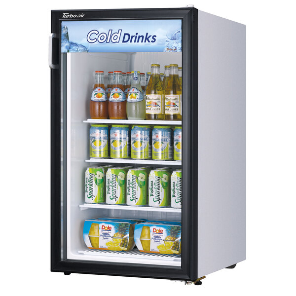 A Turbo Air white countertop display refrigerator with a glass swing door full of beverages.
