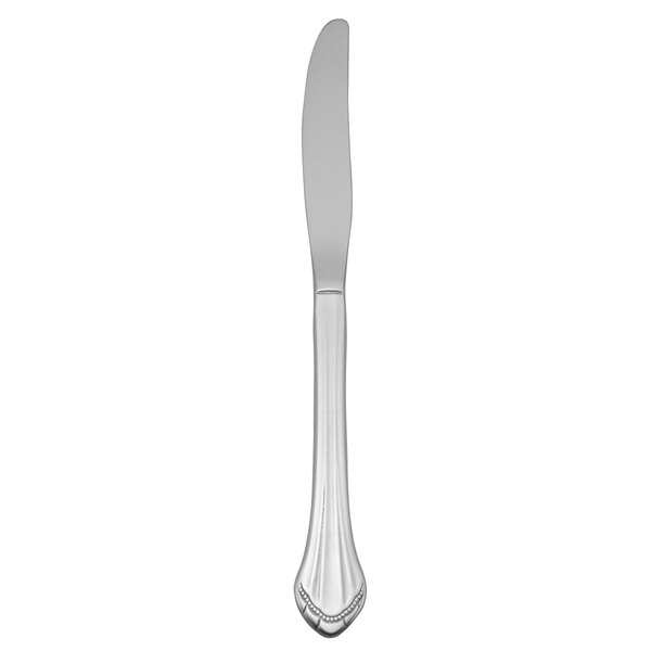 A Oneida Marquette stainless steel dinner knife with a white handle.