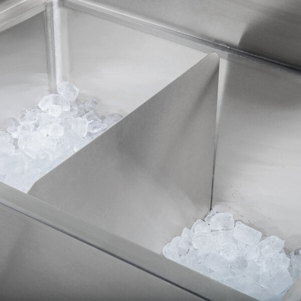 A stainless steel Regency ice bin partition with ice cubes inside.