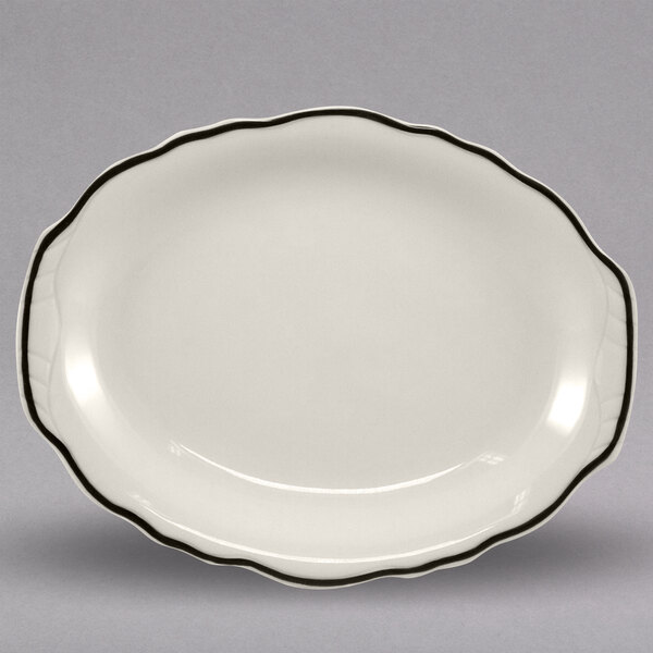 A white oval china platter with black trim.