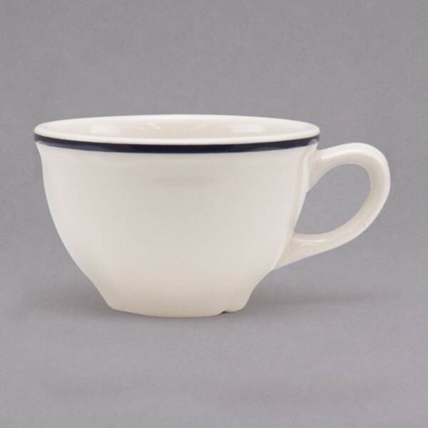 A white Homer Laughlin Scalloped China cup with a handle.