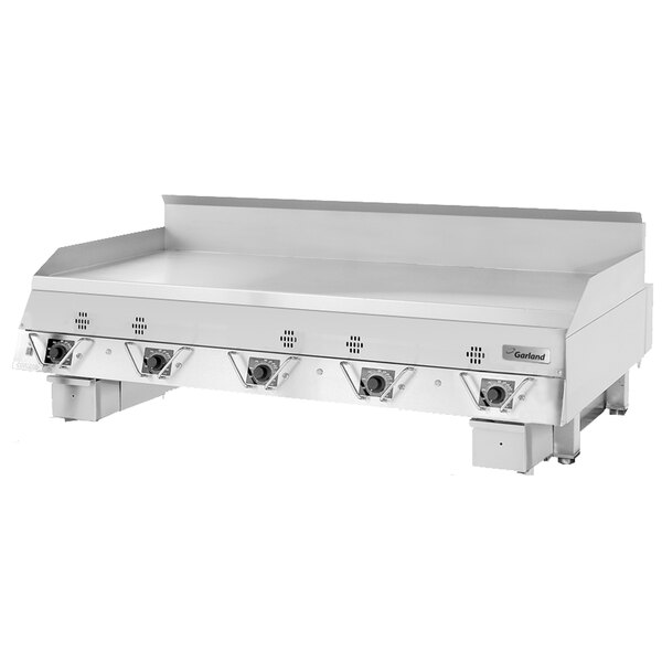A large stainless steel Garland Master Series gas griddle with four knobs.