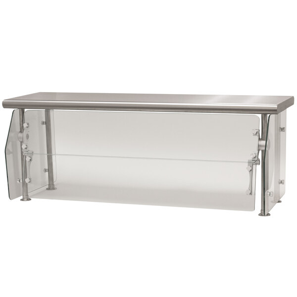 A stainless steel counter with a glass food shield on a clear glass shelf.