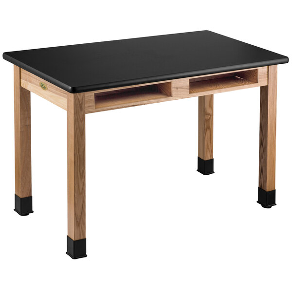 A black National Public Seating science lab table with wooden legs.