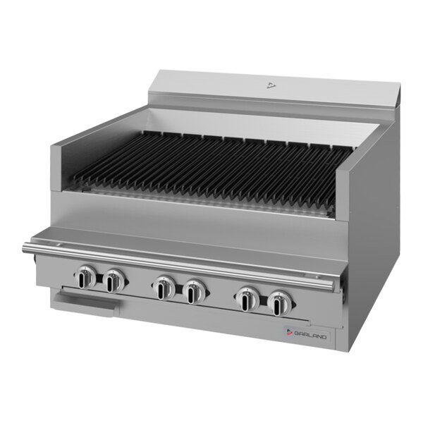 A stainless steel Garland charbroiler with two black grills over three burners.