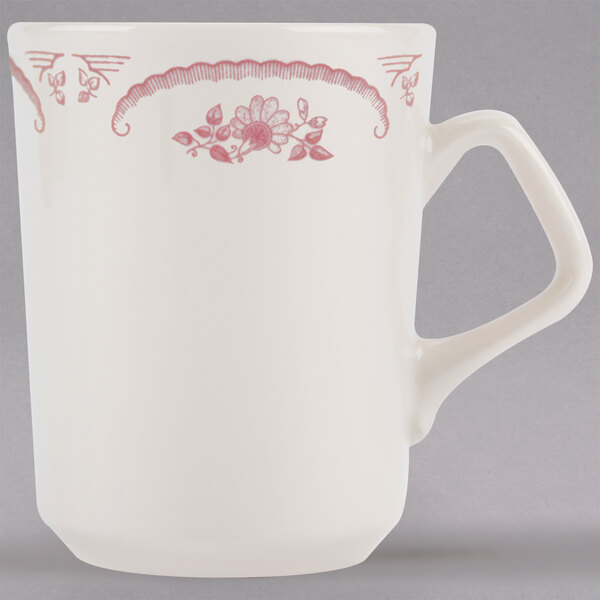 A white Homer Laughlin mug with pink rose designs.