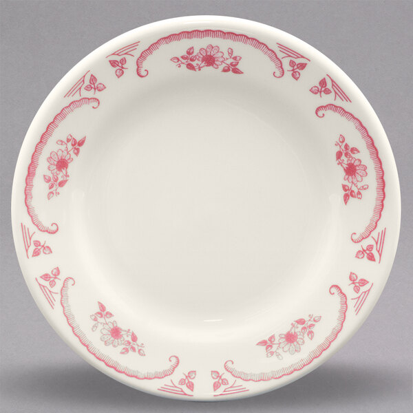 A white Homer Laughlin china bread and butter plate with red roses.