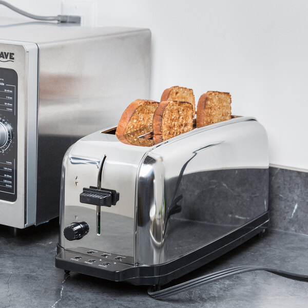 A Waring commercial toaster with two slices of toasted bread in it.
