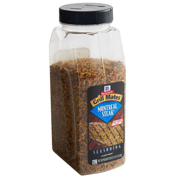 A plastic container of McCormick Grill Mates Montreal Steak Seasoning.