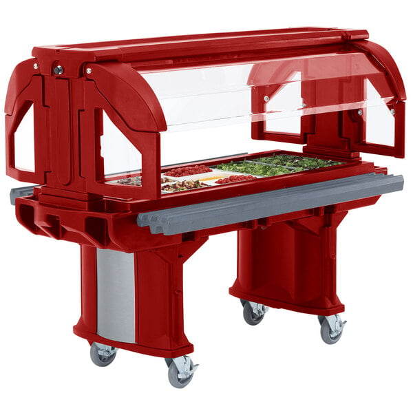 A red Cambro Versa food and salad bar on wheels with a tray of food.