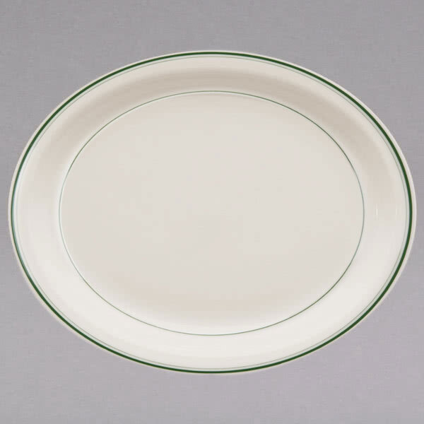A white oval china platter with a green band on the rim.