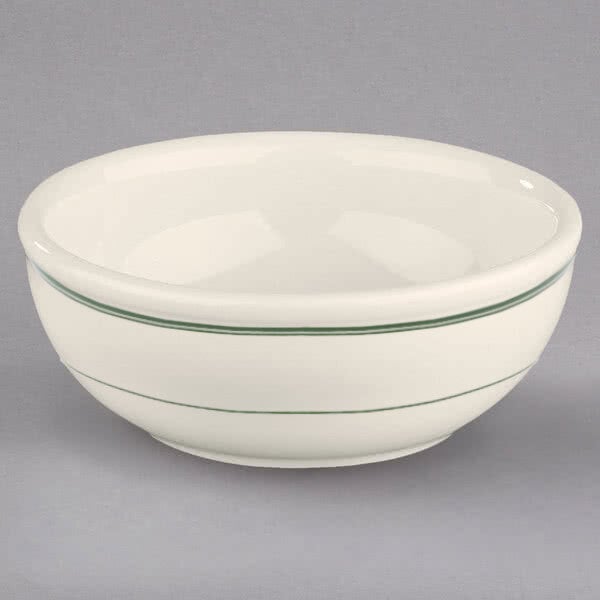 A white bowl with green stripes on it.