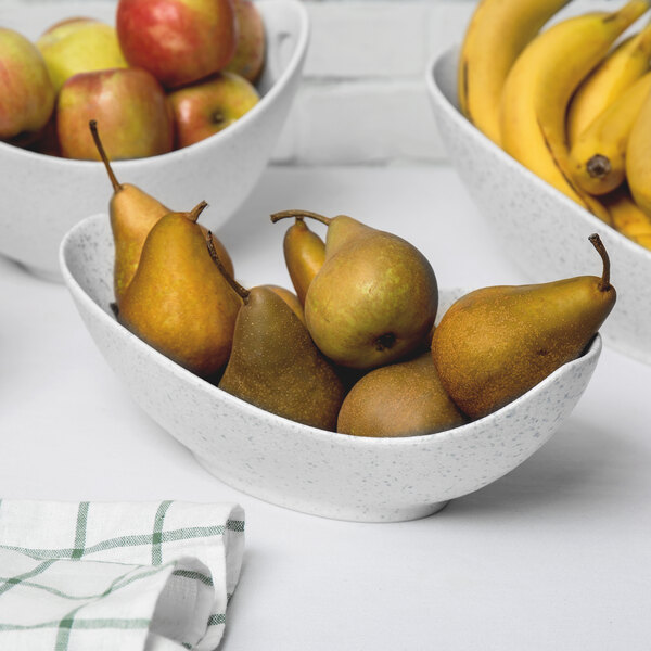 A blue speckled porcelain canoe bowl filled with pears and bananas.
