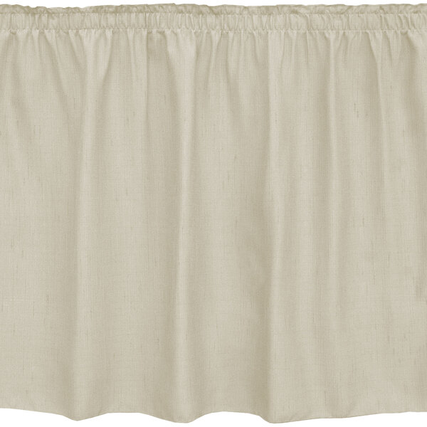 A white table skirt with a ruffled edge and beige trim.