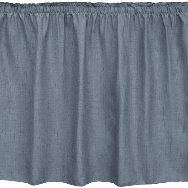 A slate blue table skirt with ruffled edges.